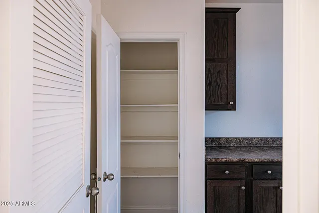 a kitchen with a refrigerator and a stove