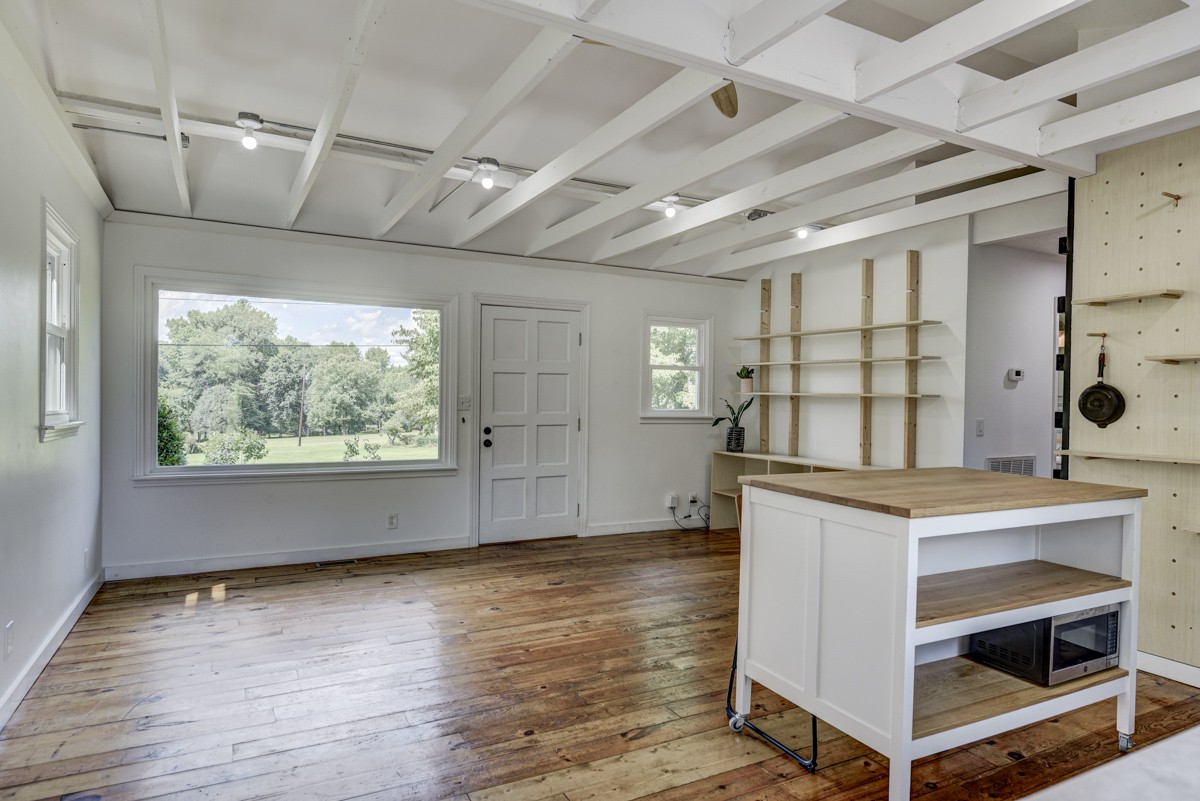 341 Lee Road Cottontown, TN 37048 - Photo 11 of 43 an empty room with wooden floor and windows