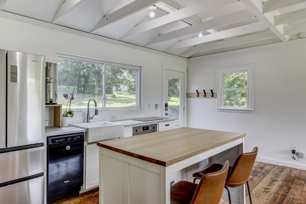 341 Lee Road Cottontown, TN 37048 - Photo 17 of 43 a kitchen with a stove a refrigerator and a dining table