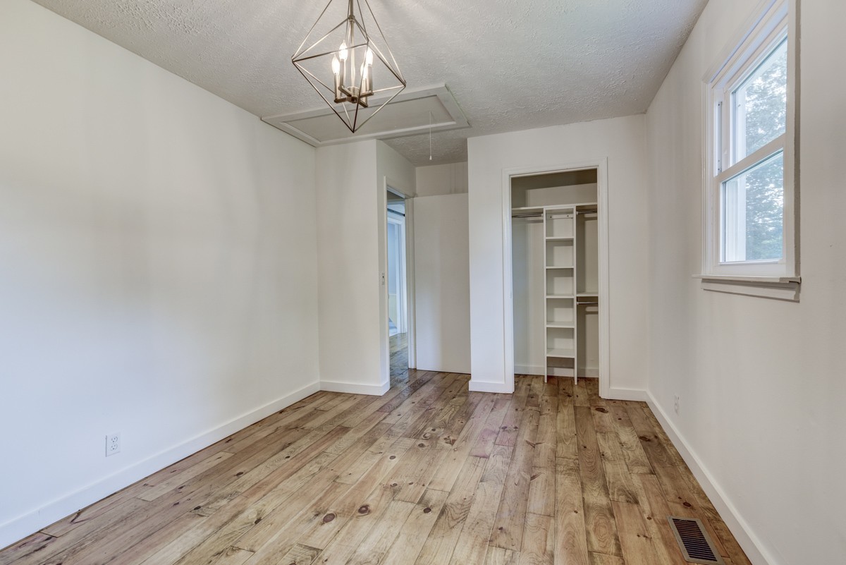 341 Lee Road Cottontown, TN 37048 - Photo 22 of 43 a view of empty room with wooden floor