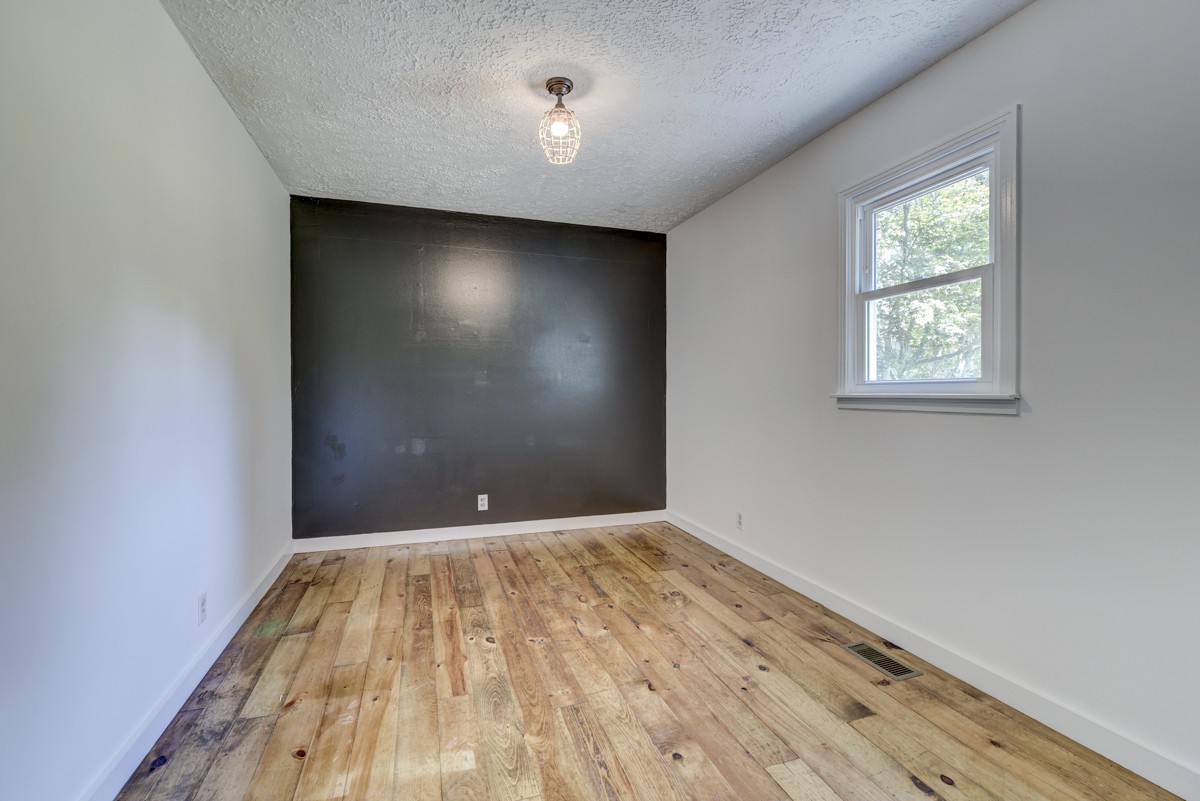 341 Lee Road Cottontown, TN 37048 - Photo 25 of 43 an empty room with wooden floor and windows
