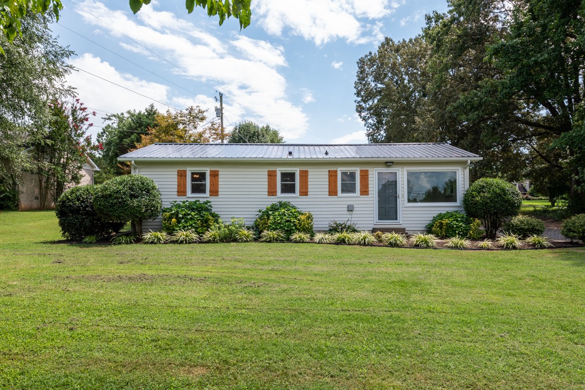 341 Lee Road Cottontown, TN 37048 - Photo 5 of 43 a front view of a house with a garden