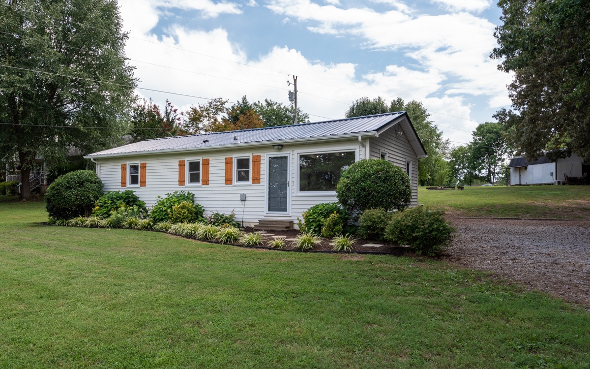 341 Lee Road Cottontown, TN 37048 - Photo 6 of 43 a front view of a house with a garden