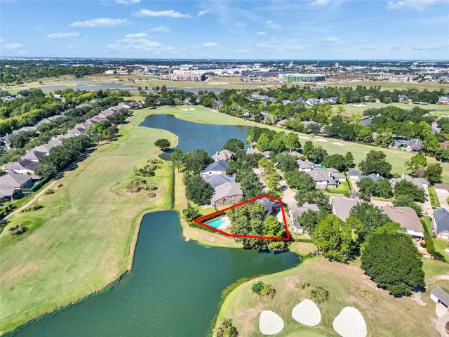 an aerial view of residential houses with outdoor space and swimming pool