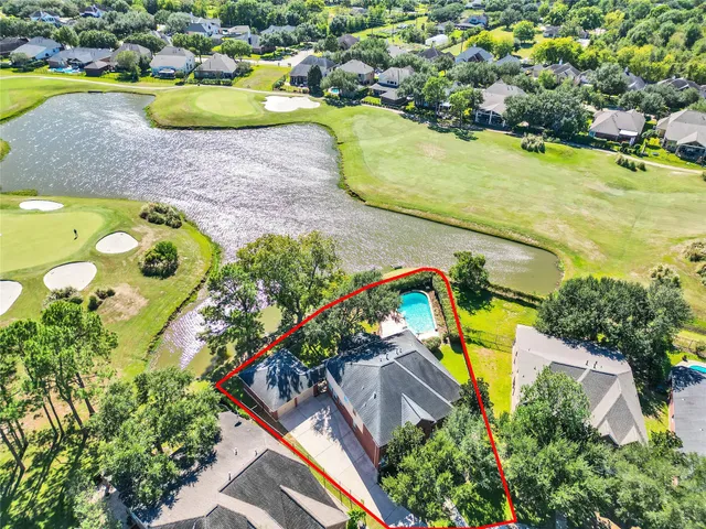 a view of a livingroom with a fireplace a chandelier and wooden floor