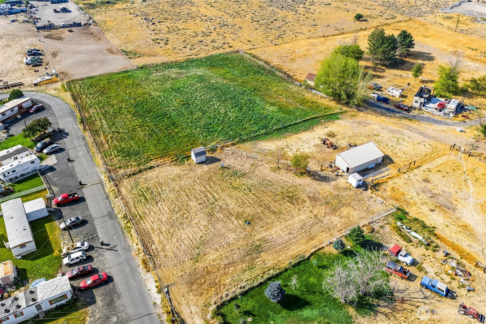 9749 Harris Road Northeast Moses Lake, WA 98837 - Photo 23 of 25 a backyard of a house with lots of green space and plants