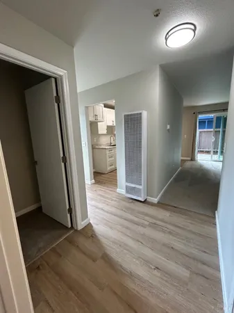 an empty room with wooden floor and a window