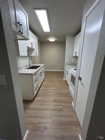 a kitchen with stainless steel appliances a sink and cabinets