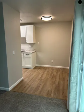 an empty room with wooden floor and a window