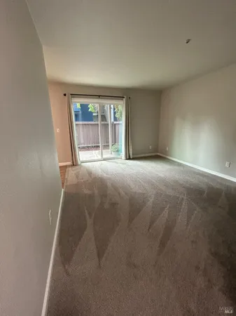an empty room with large windows