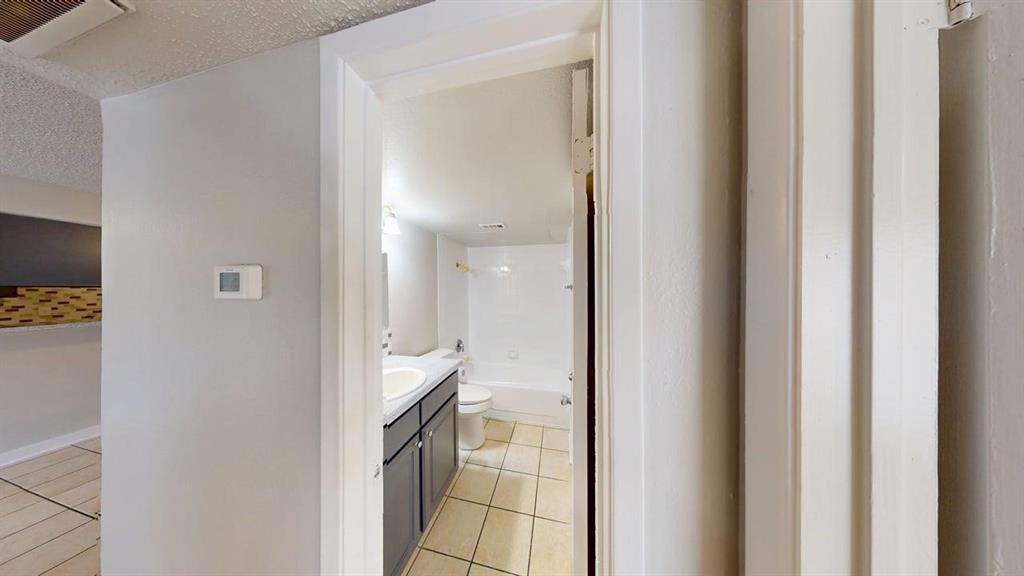 8110 Skillman Street, Unit 1046 Dallas, TX 75231 - Photo 10 of 10 a view of a bathroom from a hallway