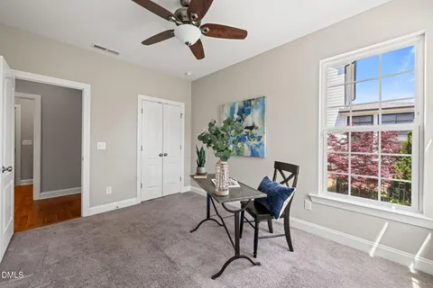 a workspace room with furniture and window