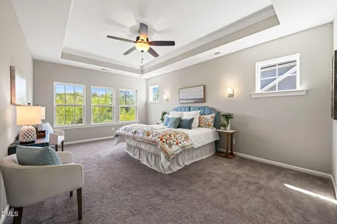 a bed room with a bed and a ceiling fan