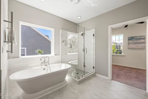a spacious bathroom with double vanity and a mirror