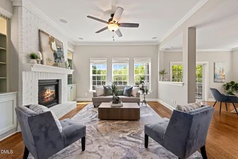 a living room with furniture fireplace and a large window