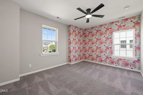 a view of a livingroom with a ceiling fan and window