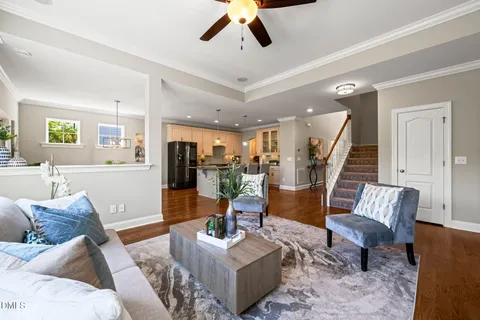 a living room with furniture and wooden floor