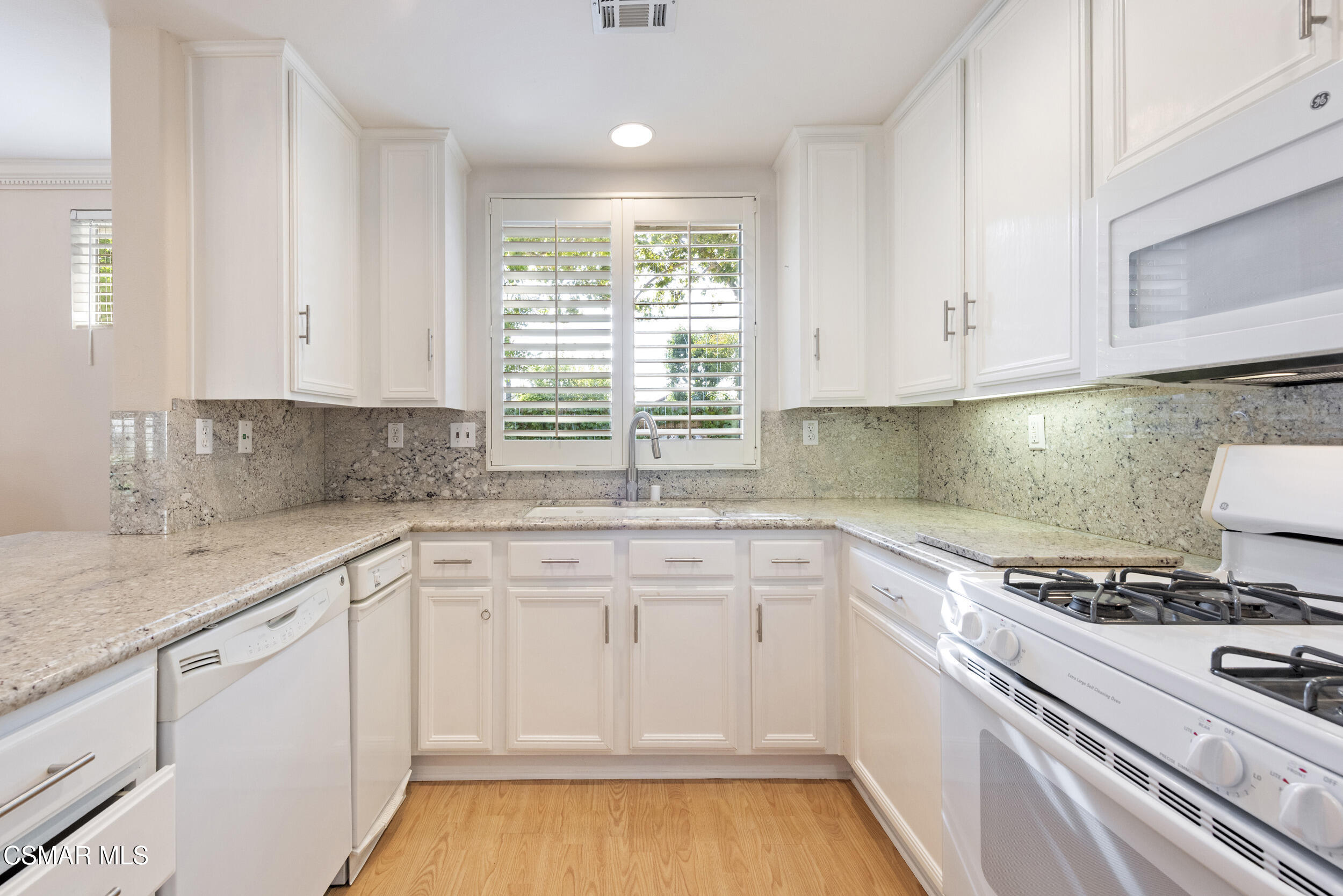 2059 Tulip Avenue Simi Valley, CA 93063 - Photo 12 of 37 a white kitchen with granite countertop white cabinets and white appliances