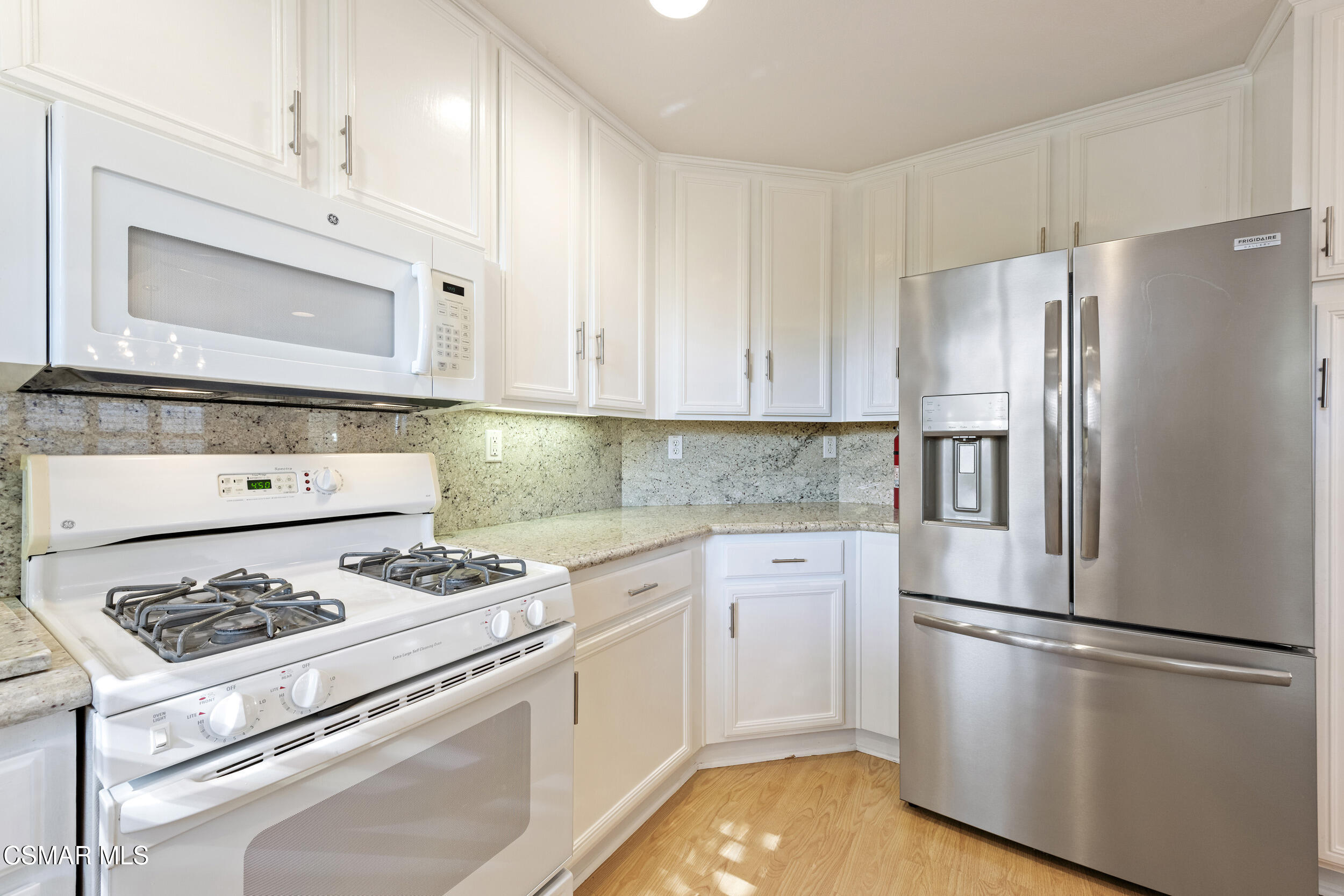 2059 Tulip Avenue Simi Valley, CA 93063 - Photo 13 of 37 a white refrigerator freezer and a stove in a kitchen