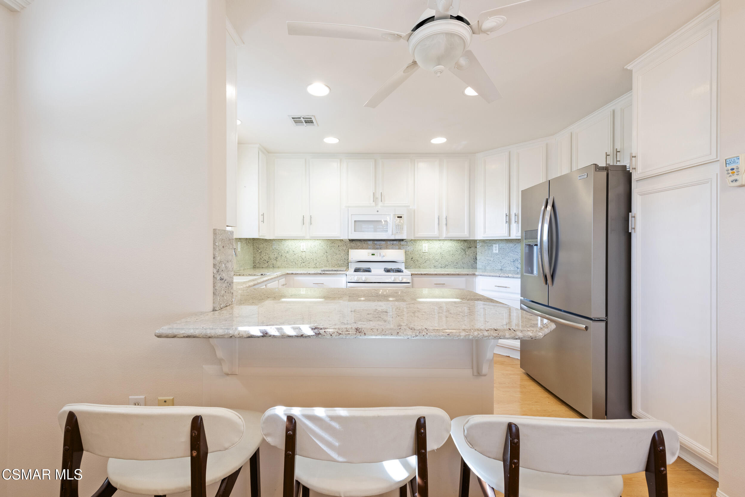 2059 Tulip Avenue Simi Valley, CA 93063 - Photo 10 of 37 a kitchen with stainless steel appliances granite countertop a refrigerator and a stove top oven