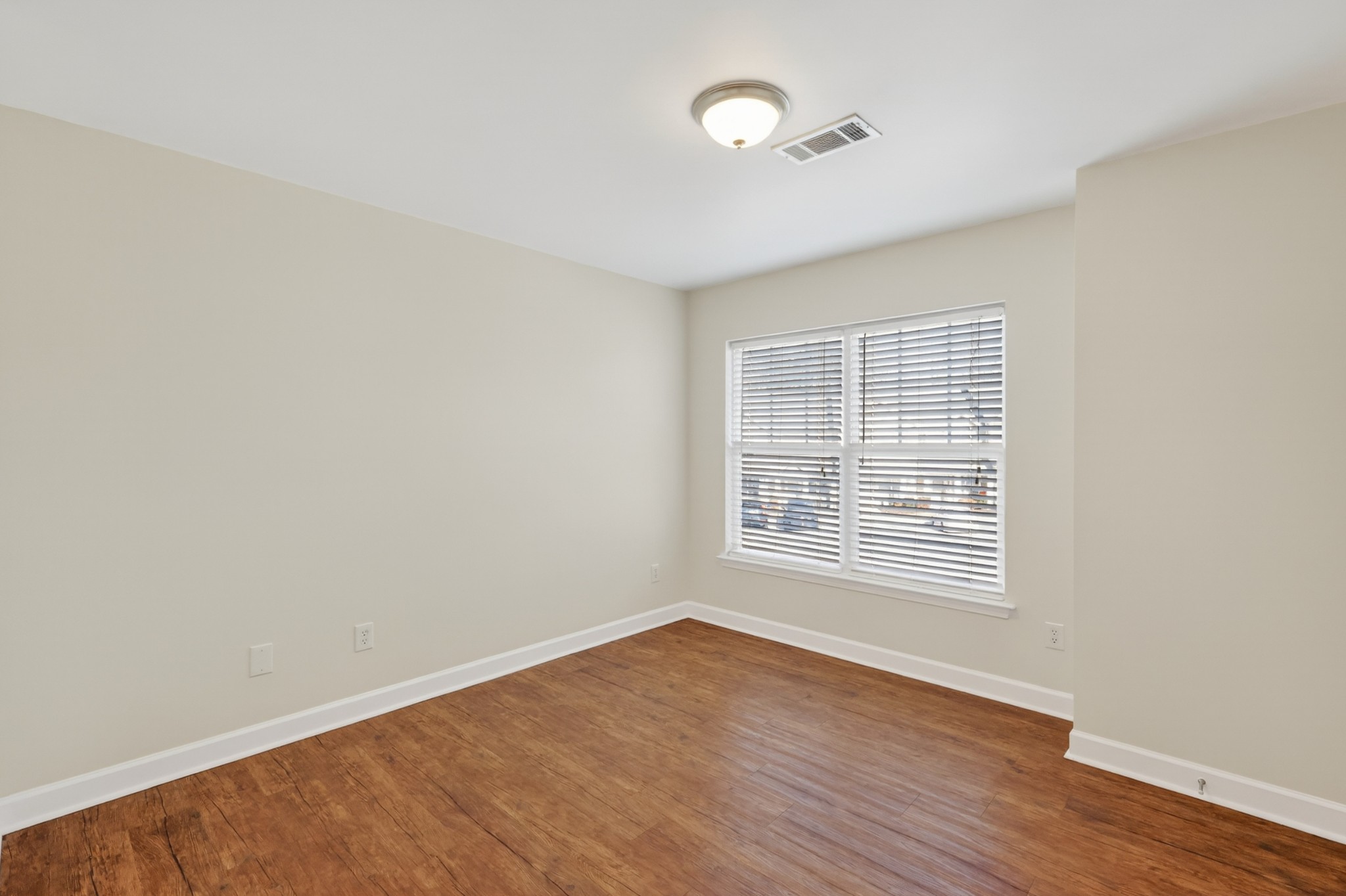 3535 Bell Road, Unit 103 Nashville, TN 37214 - Photo 17 of 29 an empty room with wooden floor and windows