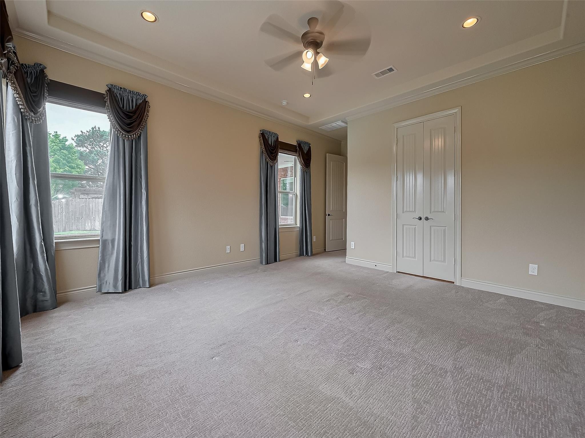 2711 King Point View Lane Spring, TX 77388 - Photo 16 of 48 This spacious primary bedroom with neutral tones, large windows with elegant drapery.