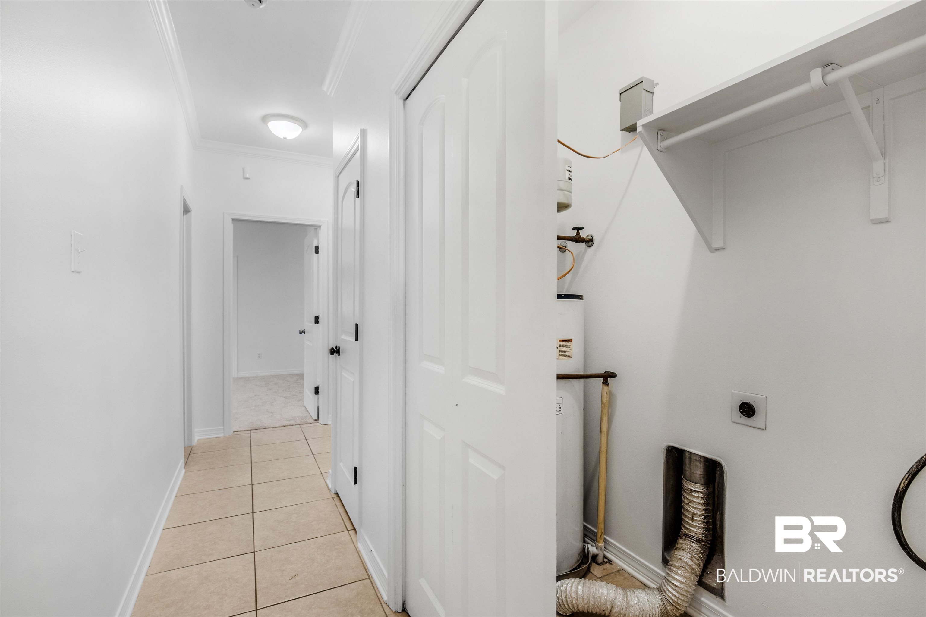 1007 Linlen Avenue Mobile, AL 36609 - Photo 13 of 21 Clothes washing area featuring water heater, light tile patterned floors, crown molding, and hookup for an electric dryer