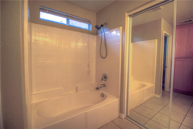 a bathroom with a bathtub and a shower