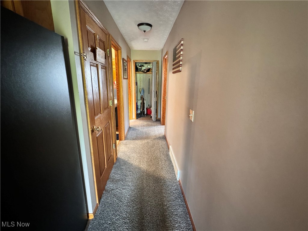 58410 Wharton Road Barnesville, OH 43713 - Photo 14 of 36 Hall featuring a textured ceiling and carpet floors