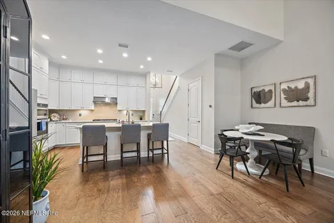 a view of a dining room with furniture and wooden floor