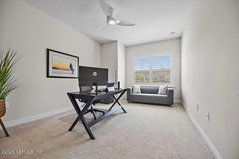 a view of a livingroom with furniture and a window