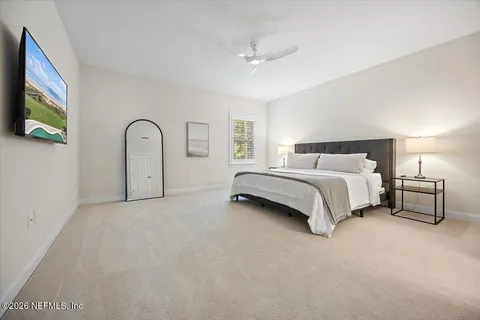 a bed room with a bed and a television