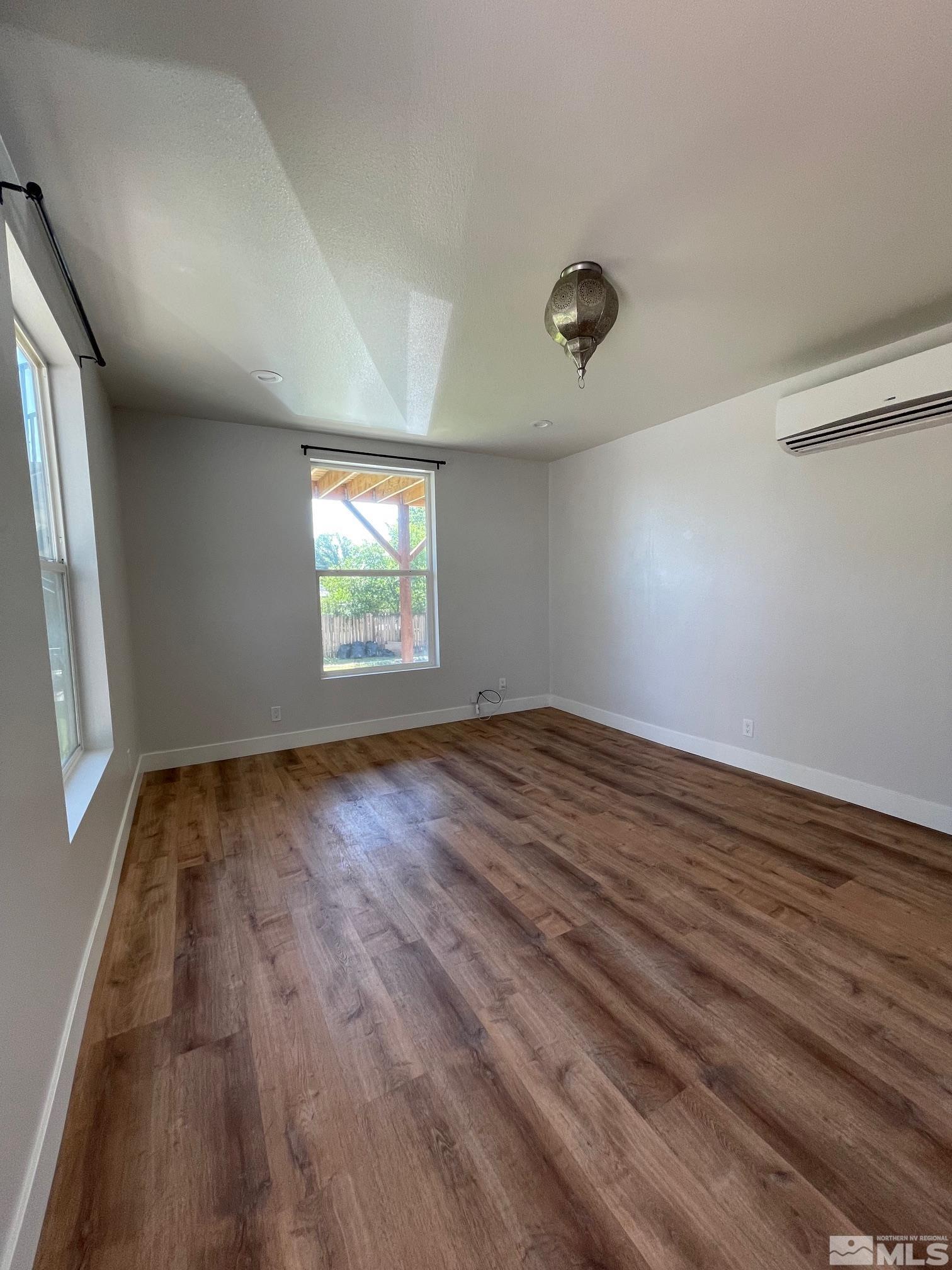 606 East 7th Street Reno, NV 89512 - Photo 16 of 35 an empty room with wooden floor and windows