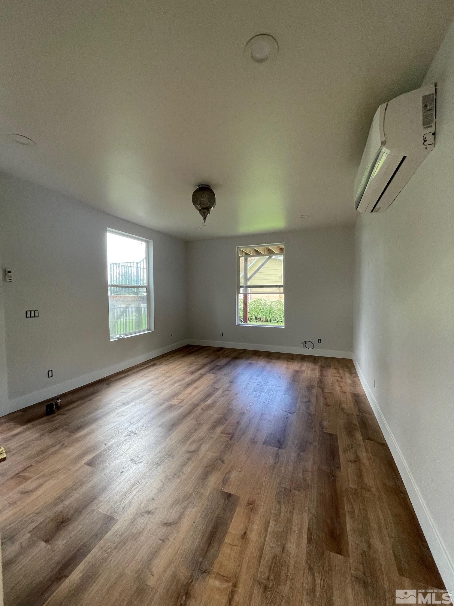 606 East 7th Street Reno, NV 89512 - Photo 20 of 35 an empty room with wooden floor and windows