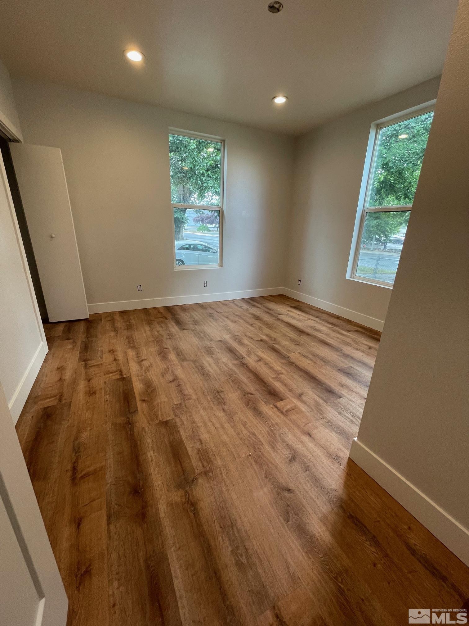606 East 7th Street Reno, NV 89512 - Photo 22 of 35 an empty room with wooden floor and windows