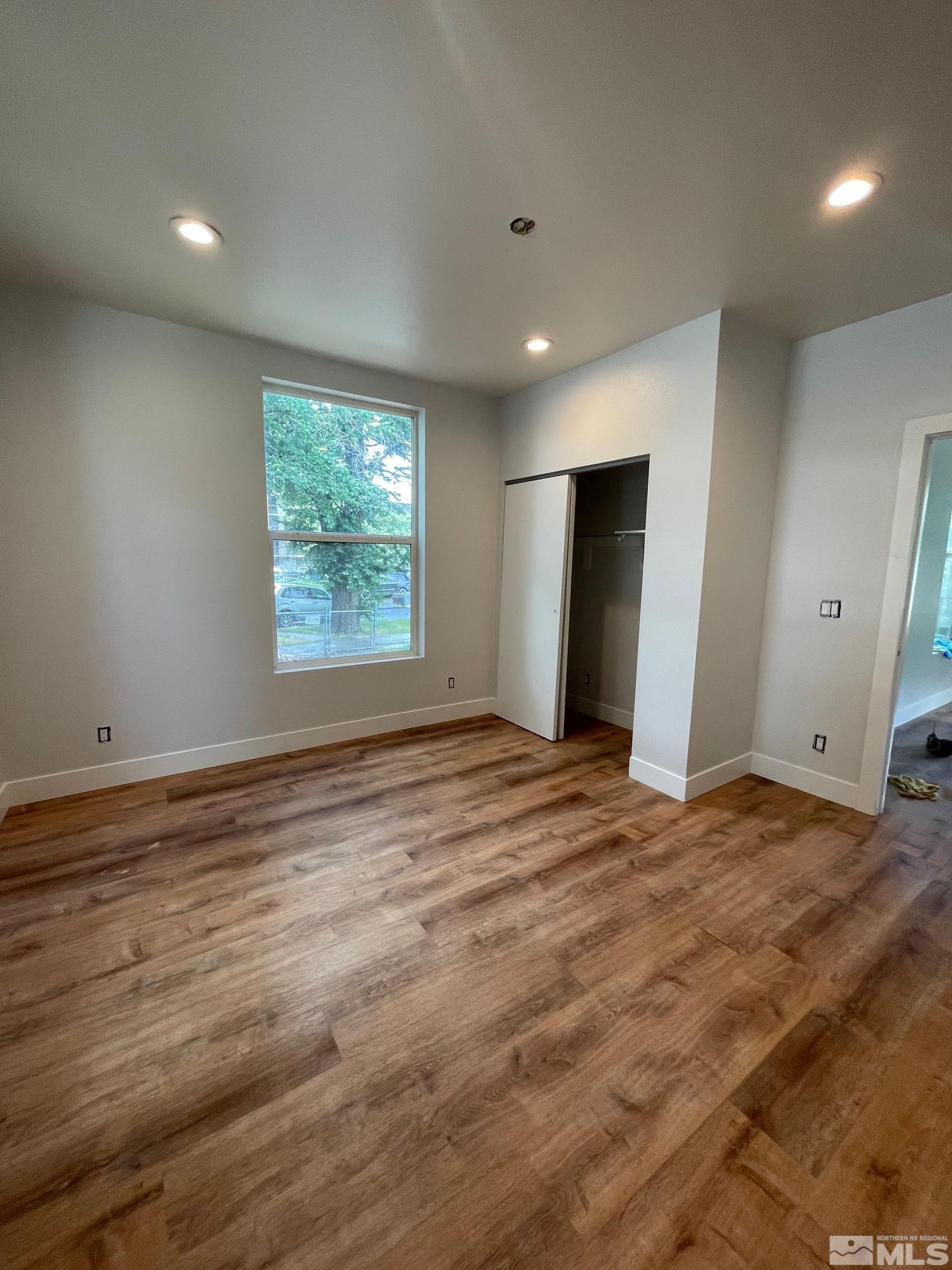 606 East 7th Street Reno, NV 89512 - Photo 24 of 35 a view of an empty room with wooden floor and a window
