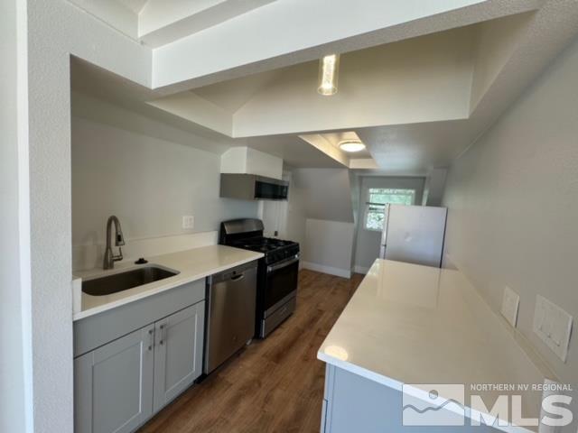 606 East 7th Street Reno, NV 89512 - Photo 26 of 35 a large kitchen with a sink and cabinets