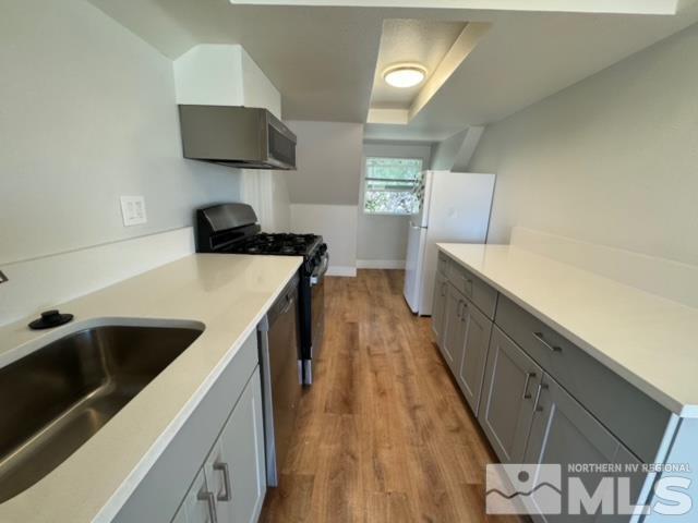 606 East 7th Street Reno, NV 89512 - Photo 27 of 35 a kitchen with a stove and a sink