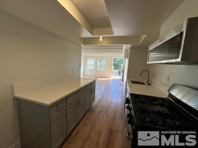 606 East 7th Street Reno, NV 89512 - Photo 28 of 35 a kitchen with wooden cabinets and a stove top oven