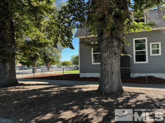 606 East 7th Street Reno, NV 89512 - Photo 3 of 35 a tree in front of a white house