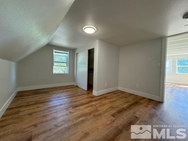 606 East 7th Street Reno, NV 89512 - Photo 31 of 35 an empty room with wooden floor and windows