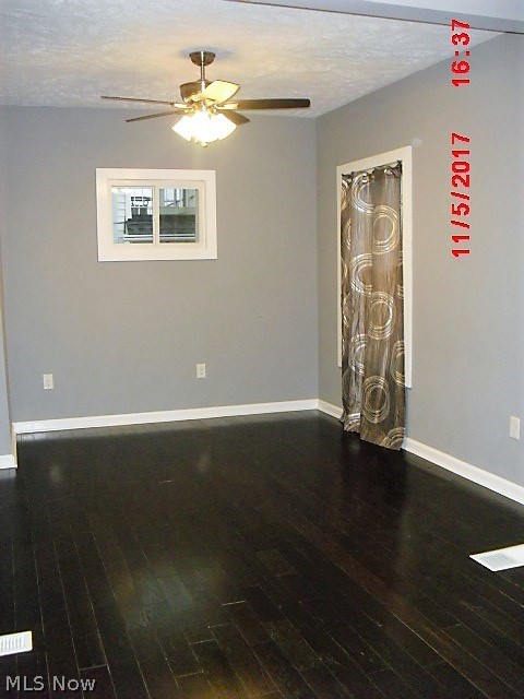 4274 Valley Road Cleveland, OH 44109 - Photo 6 of 19 Large living room with new hardwood floors and ceiling fan.