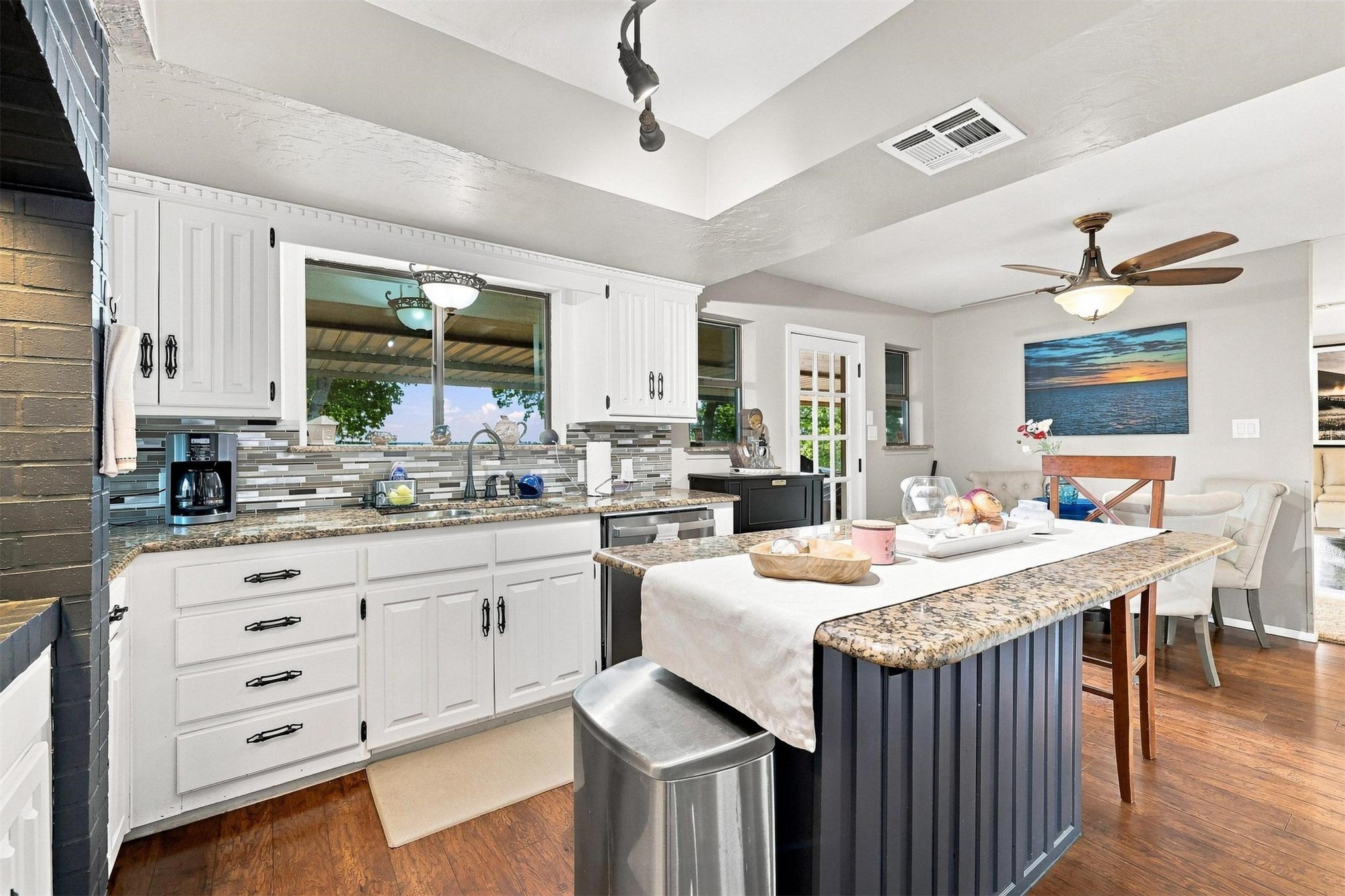 171 Woods Road Mead, OK 73449 - Photo 19 of 62 White cabinetry, a patterned tile backsplash, and granite countertops