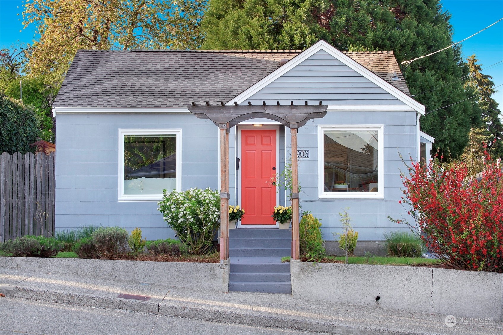 a front view of a house with a yard and trees