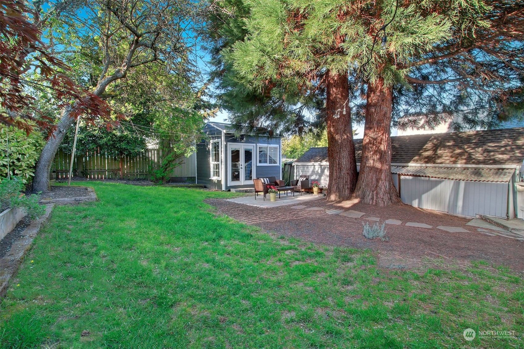 906 North 88th Street Seattle, WA 98103 - Photo 20 of 23 a view of a patio with table and chairs under an umbrella