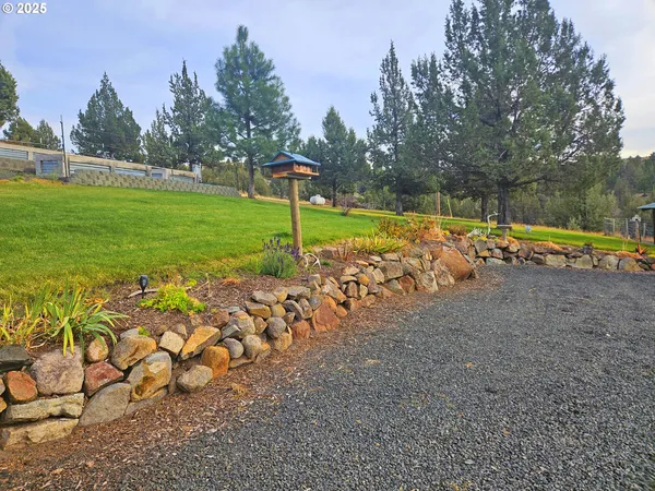 a bathroom with a granite countertop sink mirror vanity and toilet