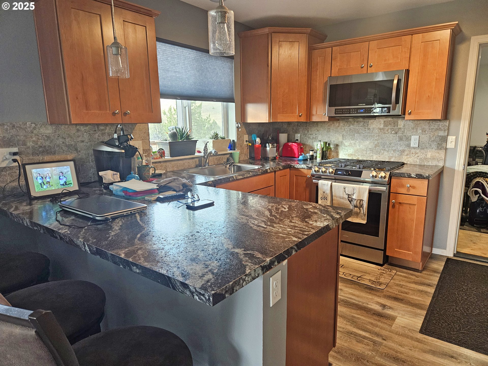 46457 Highway 218 Fossil, OR 97830 - Photo 23 of 45 a kitchen with stainless steel appliances granite countertop a sink stove and microwave