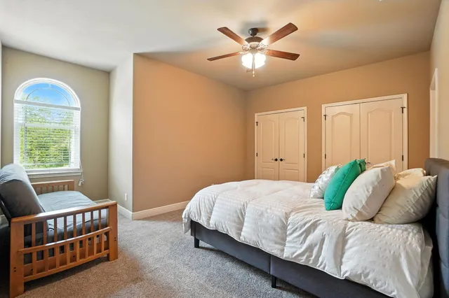 a bedroom with a bed and a chandelier