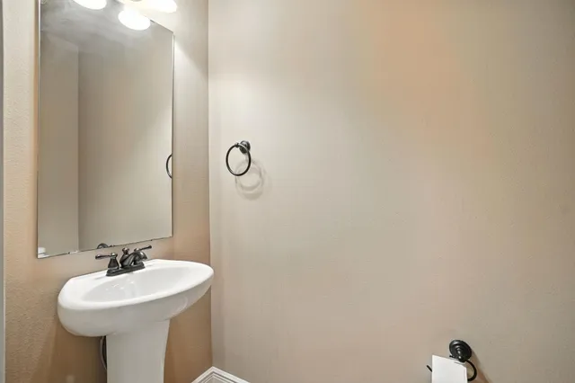 a bathroom with a sink and mirror