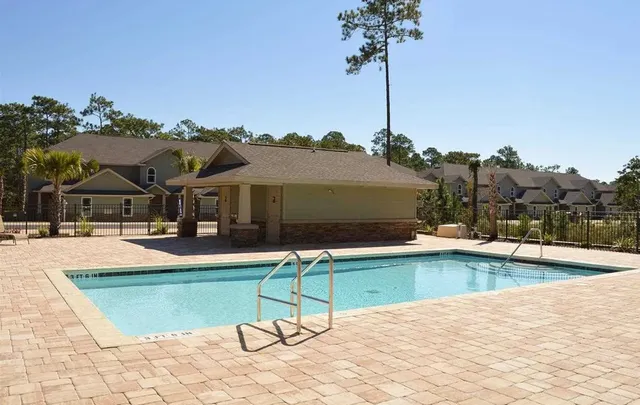 a view of a house with swimming pool and sitting area